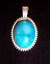 pendant, turquoise, silvertone bead pattern mount, 30x22